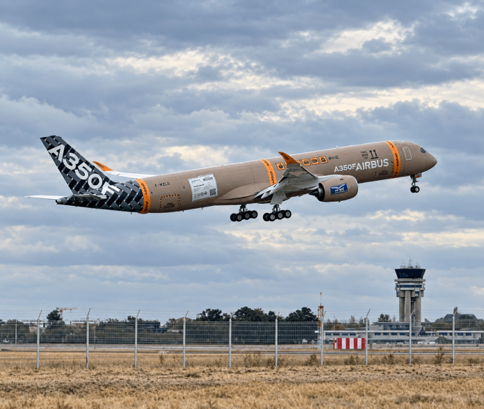 Airbus A350F first flight test aircraft climbing after takeoff from Toulouse with landing gear still extended.
