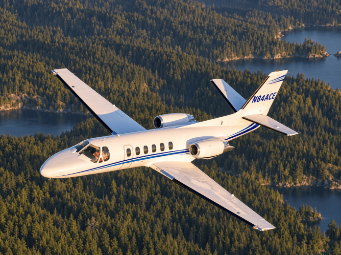 Cessna Citation flying over a Northwest forest, used for our Citation single-pilot exemptions article.