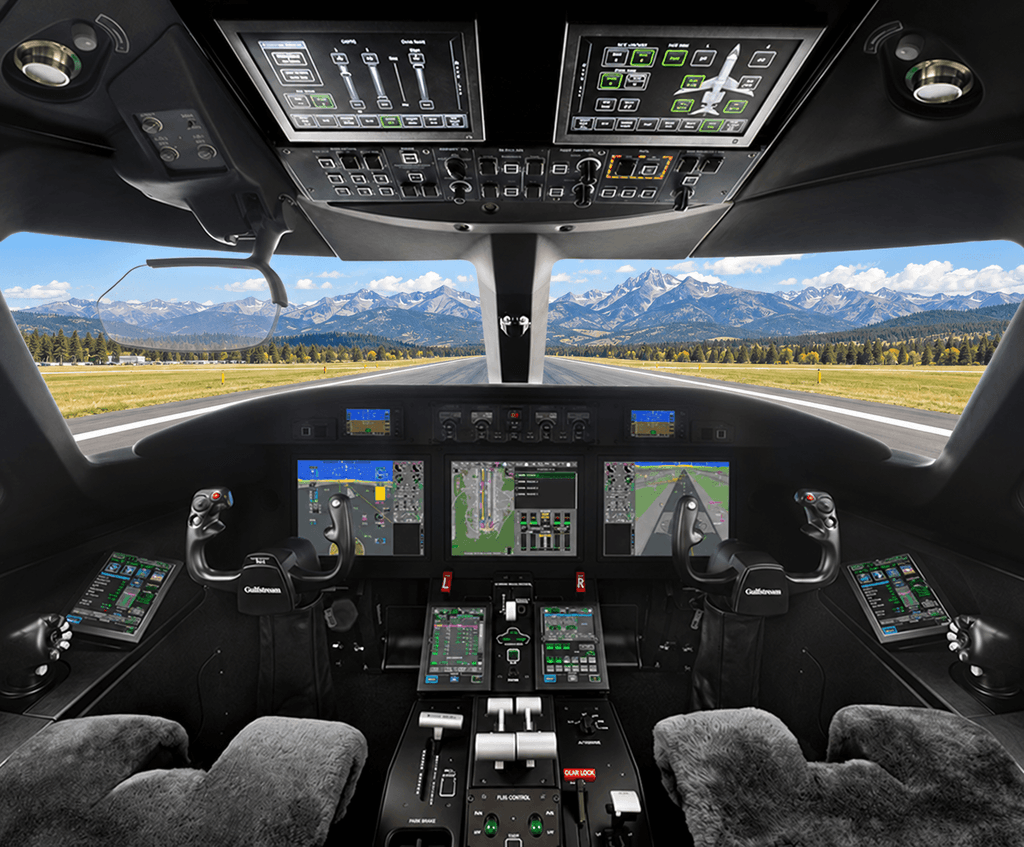 Gulfstream G300 review cockpit image showing Harmony avionics, dual control yokes and a runway with Colorado mountains beyond the windshield.