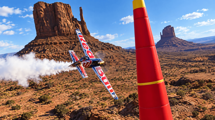 MSFS 2024 Sim Update 7 air racing aircraft flying past a red pylon over a desert landscape in daylight.